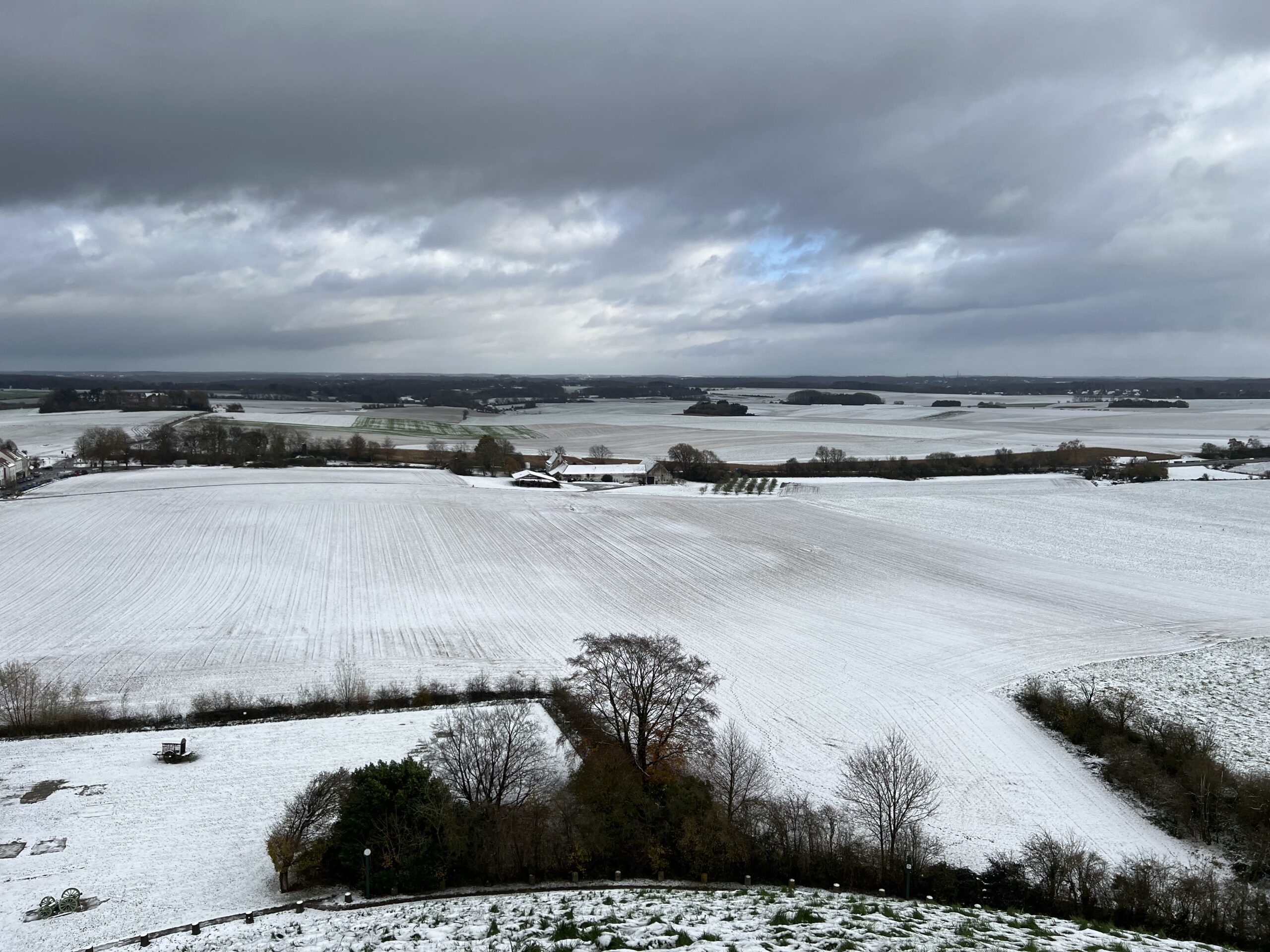 Snowy view from the Lion Mound looking across to the farm and orchard of La Haye Sainte